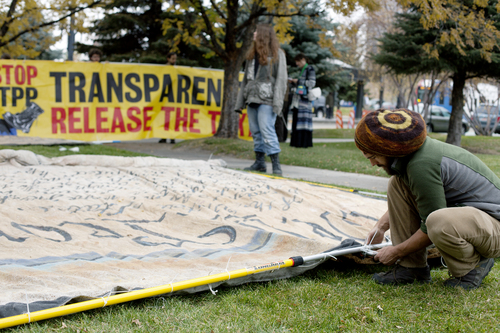 Jim McAuley | The Salt Lake Tribune
Eric Ross of the Backbone Campaign prepares the finishing touches on signs to protest the Trans-Pacific Partnership talks outside of the Grand American Hotel in Salt Lake City on Tuesday, November 19, 2013.