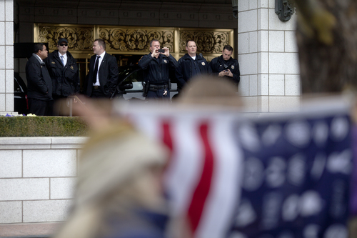 Jim McAuley | The Salt Lake Tribune
Security and police personnel take cell phone photoso of the protest forming against the Trans-Pacific Partnership talks at the Grand America Hotel in Salt Lake City on Tuesday, November 19, 2013.