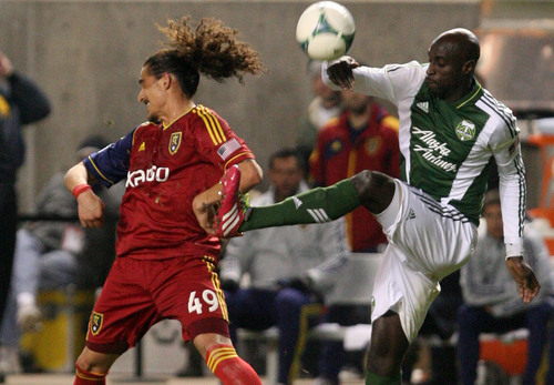 Leah Hogsten  | The Salt Lake Tribune
Real Salt Lake forward Devon Sandoval (49) and Portland Timbers defender Mamadou Danso (98) fight for possession. Real Salt Lake defeated the Portland Timbers 4-2  during their first leg of the Western Conference final series Sunday, November 10, 2013 at Rio Tinto Stadium.