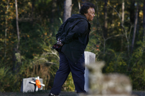 Scott Sommerdorf   |  The Salt Lake Tribune
Johnnie Mae Martin walks through the cemetery in Monticello, Mississippi, where bother her husband, and son David are buried, Tuesday November 19, 2013. Her son's grave is at left.