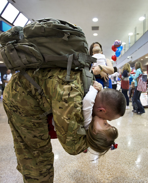 Lennie Mahler  |  The Salt Lake Tribune
Kaj Petersen embraces his daughter, Gabrielle, at the Salt Lake City International Airport, Thursday, Nov. 21, 2013. Two pilots and four crew members of the Utah Army National Guard returned to Utah from a nine-month deployment to Afghanistan.