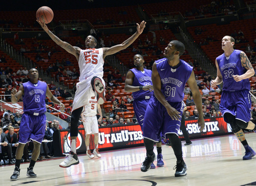 Chris Detrick  |  The Salt Lake Tribune
Utah Utes guard Delon Wright (55) shoots past Grand Canyon Antelopes' Justin Foreman (5) and Jeremy Adams (31) during the first half of the game at The Huntsman Center Thursday November 21, 2013. Utah is winning 37-20 at halftime.