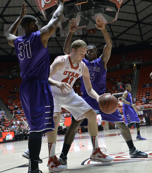 Chris Detrick  |  The Salt Lake Tribune
Utah Utes center Jeremy Olsen (41) is guarded by Grand Canyon Antelopes' Jeremy Adams (31) and Justin Foreman (5) during the first half of the game at The Huntsman Center Thursday November 21, 2013. Utah is winning 37-20 at halftime.