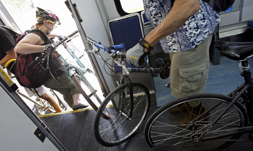 Ruthann Shurtleff(cq) exits a TRAX car filled with other bike commuters after she stopped driving last December and sold her car last month.  With the price of gas skyrocketing more commuters are using alternate forms of transportation.    Photo by Francisco Kjolseth/The Salt Lake Tribune 6/24/2008