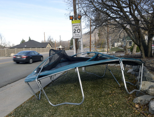 Al Hartmann  |  The Salt Lake Tribune
Bent trampoline frame from Thursday's high winds lies along Main Street in Farmington Friday November 22.