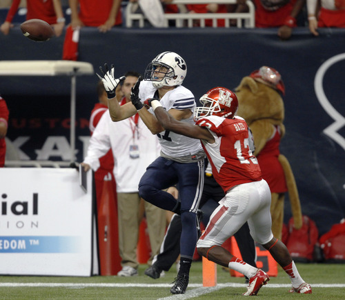 BYU's Skyler Ridley, left, catches the game-winning touchdown as Houston's Thomas Bates defends during the second half of an NCAA college football game, Saturday, Oct. 19, 2013 in Houston. BYU defeated Houston, 47-46. (AP Photo/Eric Christian Smith)