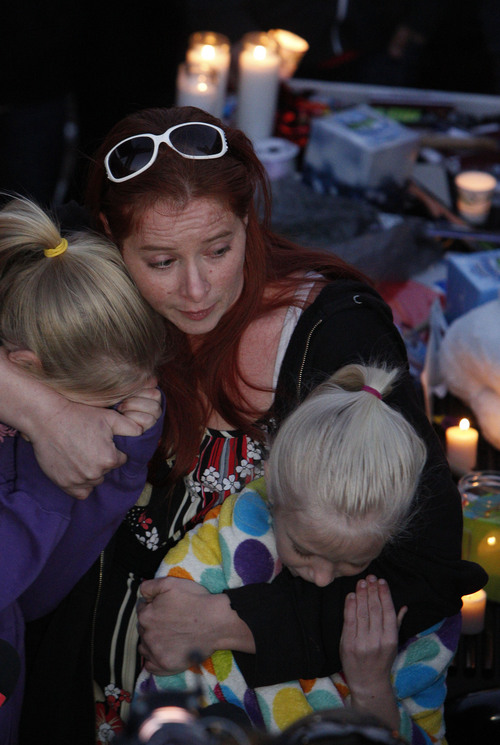 Francisco Kjolseth  |  The Salt Lake Tribune
Charlé Meier comforts her two daughters Kendyll Stewart, left, and Ariyl Meier as they are surrounded by people gathered in South Jordan at Firmont Park for a candelight vigil on Sunday, Nov. 17, 2013, in memory of her son Taylor Wheeler, 12, and Dayton Gessell, 15, after the two were found dead in a home in Daybreak on Friday.