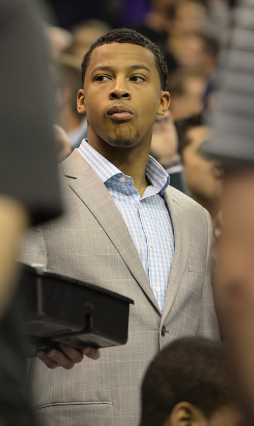 Rick Egan  | The Salt Lake Tribune 

Utah Jazz point guard Trey Burke (3) watches the game from his seat behind the Jazz bench, as The Utah Jazz faced The Golden State Warriors, at the EnergySolutions Arena, Monday, November 18, 2013.  Curry did not return to the game after the play.