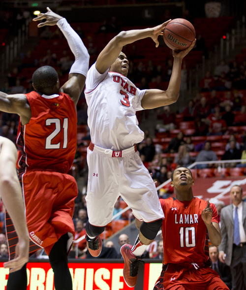 Lennie Mahler  |  The Salt Lake Tribune
Utah's Princeton Onwas drives past Lamar's Donovan Ross and Rhon Mitchell in Utah's 84-57 win Friday, Nov. 22, 2013, at the Huntsman Center. Onwas finished with 12 points and 10 rebounds.