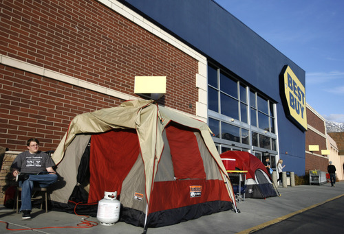 Rick Egan  | The Salt Lake Tribune 

Logan Burr, Orem sits by his tent in front to the Best Buy in Orem, Monday, November 19, 2012. Burr has been in line since Monday, November 12, waiting for the big Black Friday sale at midnight on Thursday.