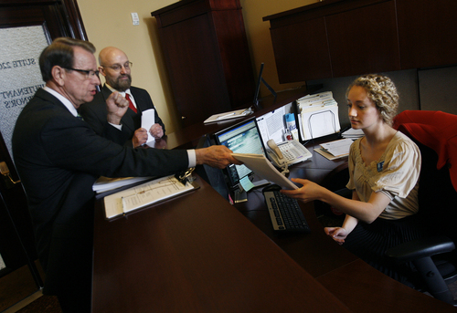 Scott Sommerdorf   |  The Salt Lake Tribune

Lt. Governor's office Administrative Assistant Laurie Decker accepts a petition from David Irvine as his attorney Alan Smith, second from left, looks on in the Lt. Governor's office, Thursday, March 7, 2013. The petition seeks to an investigation into Atty. General John Swallow's election activities and seeks statutory remedies for any violations found.
