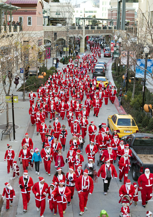Lennie Mahler  |  The Salt Lake Tribune
A group of about 600 runners dressed as Santa Claus race through the Gateway Mall for the annual 5K Santa Run on Saturday, Nov. 23, 2013.