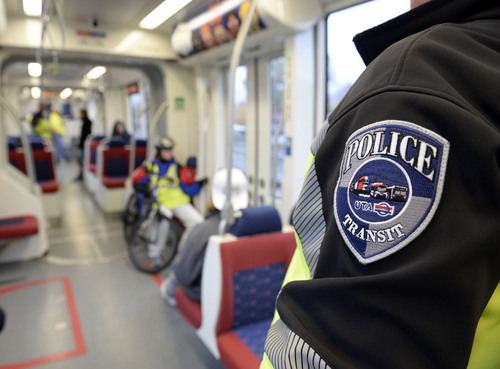 Al Hartmann  |  The Salt Lake Tribune
UTA police officers can be seen in their distinctive black and safety green colors along the TRAX line.  They want to be obvious to riders and public believing that their visibility actually keeps crime from happening.