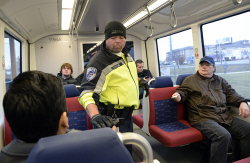 Al Hartmann  |  The Salt Lake Tribune
UTA police officer Steve Rowland checks passengers on a TRAX train for  tickets.  You never know where or when along bus or TRAX lines where they will appear to check for your  ticket.
