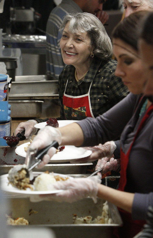 Francisco Kjolseth  |  The Salt Lake Tribune
Sylvia Gray of Salt Lake joins other volunteers as the Rescue Mission of Salt Lake serves hundreds of meals and gives away thousands of coats and warm clothes to Utahís homeless and low-income families at the annual Day-Before-Thanksgiving Banquet. The Mission also supplied haircuts, flu shots, hot showers and hygiene items along with live music and addiction counseling for the Missionís Thanksgiving guests.