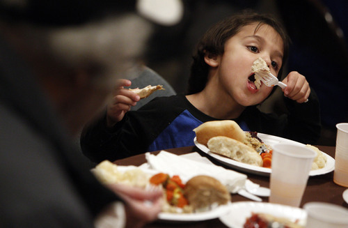 Francisco Kjolseth  |  The Salt Lake Tribune
Jordan LaChance, 4, gobbles up his turkey as the Rescue Mission of Salt Lake serves hundreds of meals and gives away thousands of coats and warm clothes to Utahís homeless and low-income families at the annual Day-Before-Thanksgiving Banquet. The Mission also supplied haircuts, flu shots, hot showers and hygiene items along with live music and addiction counseling for the Missionís Thanksgiving guests.