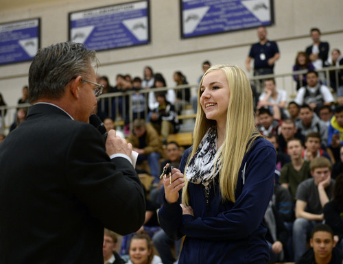 Al Hartmann  |  The Salt Lake Tribune
Hunter High School Assistant Principal Craig Stauffer presents a set of car keys to junior Kaylee Duke, who won a 2001 Honda Accord Tuesday, Nov. 26, 2013, for perfect attendance. She was the grand prize winner among a group of students with perfect attendance who spun a wheel for prizes during an assembly. Other students with perfect attendance won gift certificates, an iPad Mini and other prizes.