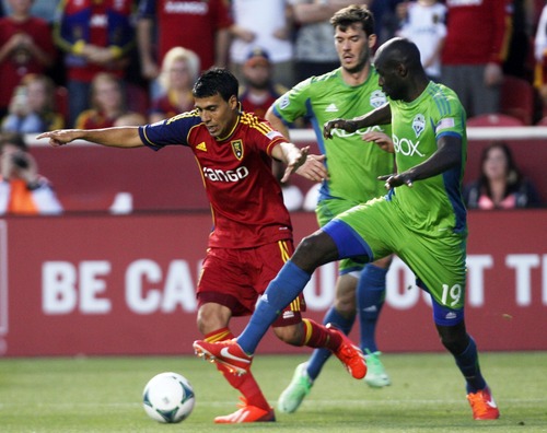 Kim Raff  |  The Salt Lake Tribune
(left) Real Salt Lake midfielder Javier Morales (11) tries to dribble past (right) Seattle Sounders FC defender Djimi Traore (19) during the second half at Rio Tinto Stadium in Sandy on June 22, 2013. Real went on to win the game 2-0.