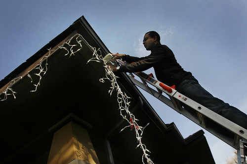 Scott Sommerdorf   |  The Salt Lake Tribune
Mohamed Baayd puts up his Christmas light on his home in Sugarhouse, Wednesday November 27, 2013.