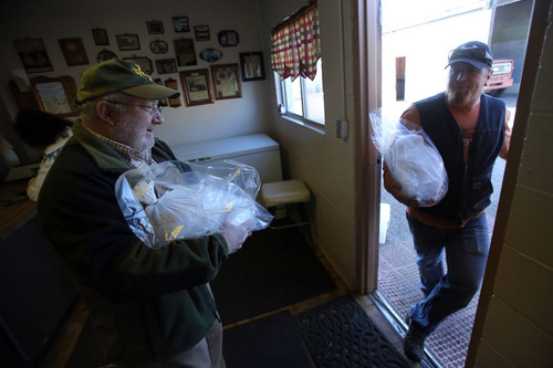 Francisco Kjolseth  |  The Salt Lake Tribune
Steve Johnson, left, a retired obstetrician from South Ogden gets help with a turkey from Dustin Hess, the grandson of the founder of Wight's Poultry Farm in Weber County. The farm sells 4,700 fresh turkeys for Thanksgiving from their small retail shop on the farm west of Ogden.