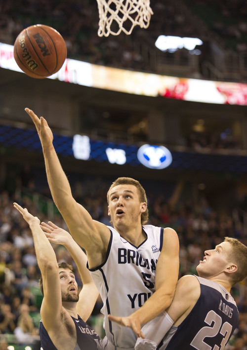 Lennie Mahler  |  The Salt Lake Tribune
BYU's Kyle Collinsworth scores a bucket over Utah State's Kyle Davis in the first half of their game at EnergySolutions Arena in Salt Lake City, Saturday, Nov. 30, 2013.