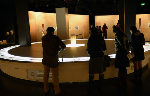 Al Hartmann  |  The Salt Lake Tribune
People look at individual pieces or writings in the Scroll Gallery at the Dead Sea Scrolls exhibit at The Leonardo in Salt Lake City.  The lidded jar in center is from one of the original caves where the scrolls were found.