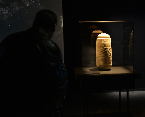 Al Hartmann  |  The Salt Lake Tribune
A visitor looks at a pottery "Scroll" Jar and lid, Khirbet Qumran from 1st centery BCE-68 CE in the Desert Orientation Theater at the Dead Sea Scrolls exhibit at The Leonardo in Salt Lake City.