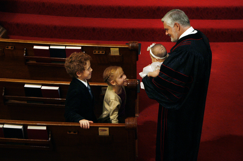 Scott Sommerdorf   |  The Salt Lake Tribune
Pastor Michael Imperiale introduces young Sydney Phillips to the congregation after conducting the sacrament of baptism for her at First Presbyterian Church on South Temple, Sunday November 24, 2013.
