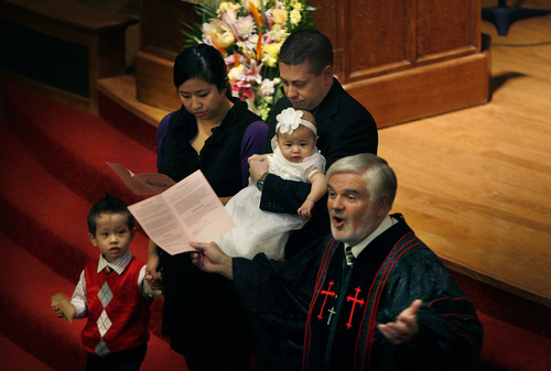 Scott Sommerdorf   |  The Salt Lake Tribune
Pastor Michael Imperiale conducts the sacrament of baptism for Sydney Phillips during service at First Presbyterian Church on South Temple, Sunday November 24, 2013.