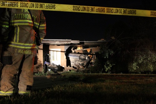 Kyle Kester  |  Special to the Tribune
Emergency crews investigate the scene at about 4400 South Stratton Drive in Holladay where a driver careened into a home, leaving it uninhabitable. Authorities said there was a family present in the house, but nobody was injured.