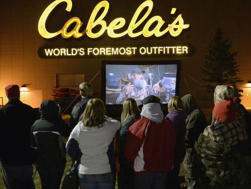 Al Hartmann  |  The Salt Lake Tribune
People lined up in front of Cabela's in Lehi Friday November 29 to enter the store at 5 a.m. when the doors open. Many received prizes for waiting in line.   Those towards the front of the line arrived on Thursday morning and camped out overnight.  To pass the time a giant screen shows the popular "Duck Dynasty" show.