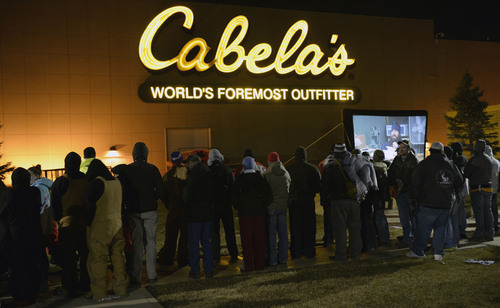 Al Hartmann  |  The Salt Lake Tribune
People lined up in front of Cabela's in Lehi Friday November 29 to enter the store at 5 a.m. when the doors open. Many received prizes for waiting in line.   Those towards the front of the line arrived on Thursday morning and camped out overnight. .  To pass the time a giant screen shows the popular "Duck Dynasty" show.