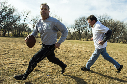 Chris Detrick  |  The Salt Lake Tribune
Chuck Hansel passes past Mark Taylor during the annual Turkey Bowl football game at Sugar House Park Thursday November 28, 2013. Member of the Crandall, Hansel and Taylor families have been continuing this Thanksgiving Day tradition for over 30 years.