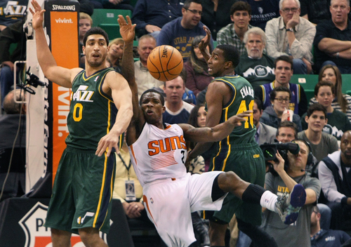 Scott Sommerdorf   |  The Salt Lake Tribune
Phoenix Suns Eric Bledsoe is fouled by Utah Jazz C Enes Kanter, left,  during second half play as Utah's Jeremy Evans looks on at right, at Energy Solutions Arena, Friday November 29, 2013. The Suns beat the Jazz 112-101.
