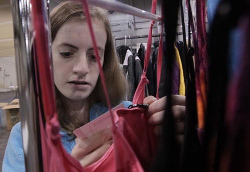 Leah Hogsten  |  The Salt Lake Tribune
Ryann Gregory ,15, hangs adult clothing at the Candy Cane Corner. Volunteers on Saturday set up this year's store, an annual collaboration between The Road Home, Volunteers of America, Utah and YWCA Utah. Parents in need can select donated gifts for their children plus clothing and housewares. The store opens Monday. Donations of new clothing, blankets and toys, plus cash donations, are being accepted.