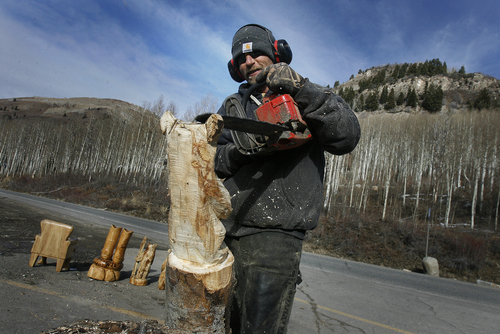 Scott Sommerdorf   |  The Salt Lake Tribune
Wood chips fly as Jim Valentine works on a chainsaw bear sculpture outside The Silver Fork Grill and Lodge up Big Cottonwood Canyon, Sunday December 1, 2013. The weekend's mild weather is changing Monday night, with snow in the forecast.