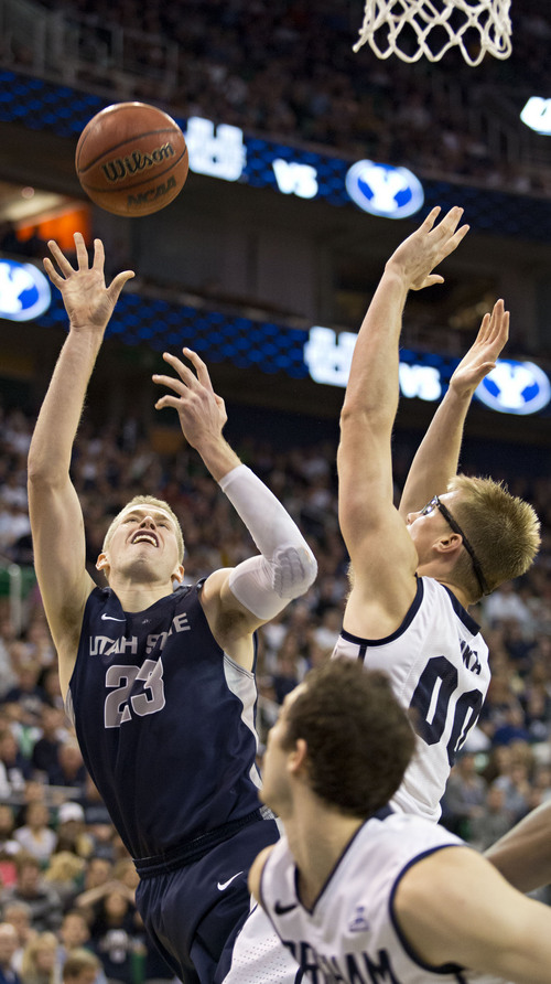 Lennie Mahler  |  The Salt Lake Tribune
Utah State's Kyle Davis shoots over BYU's Eric Mika in the second half of their game at EnergySolutions Arena in Salt Lake City, Saturday, Nov. 30, 2013.