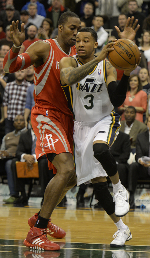 Rick Egan  | The Salt Lake Tribune 

Utah Jazz point guard Trey Burke (3) looks for someone to hand the ball off too, in NBA action, Utah Jazz vs. the Houston Rockets, at the EnergySolutions Arena, Monday, December 2, 2013.