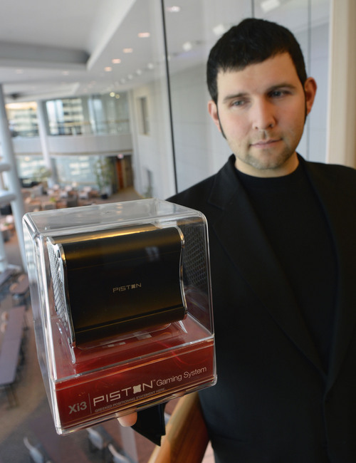 Al Hartmann  | The Salt Lake Tribune
Jason Sullivan, founder and CEO of Xi3 holds the new Piston "Steam Box" gaming console.  It's only about 4 inches wide and will be released the end of November.