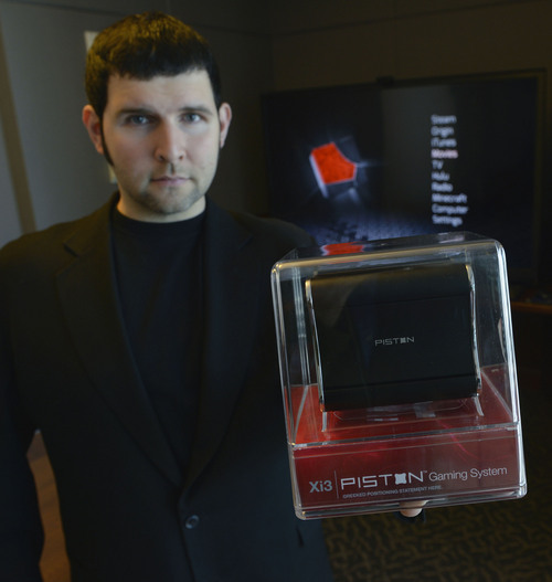 Al Hartmann  | The Salt Lake Tribune
Jason Sullivan, founder and CEO of Xi3 holds the new Piston "Steam Box" gaming console.  It's only about 4 inches wide and will be released the end of November.