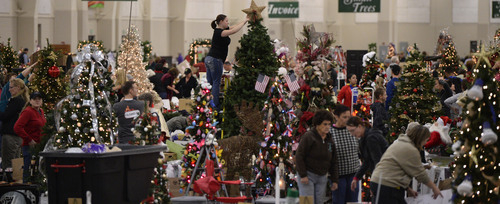 Al Hartmann  |  The Salt Lake Tribune
People fill the South Towne Exposition Center in Sandy Monday morning December 2 to decorate Christmas trees for the Festival of Trees event to raise money for Primary Children's Medical Center. The festival will be open to the public on Wednesday starting at 10 a.m.