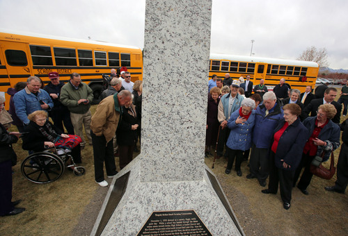 Francisco Kjolseth  |  The Salt Lake Tribune
Friends, family and relatives gather at Heritage Park in South Jordan for a 75th anniversary unveiling ceremony dedicated to a Dec. 1, 1938, school bus/train crash accident that killed 26 people, including 25 students.