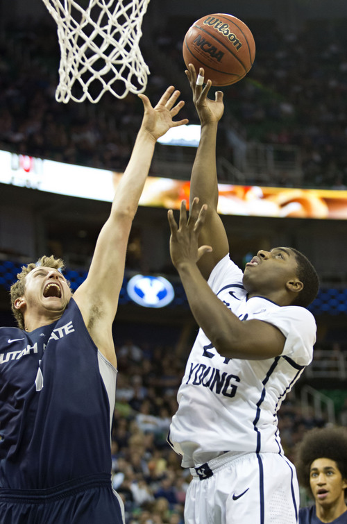 Lennie Mahler  |  The Salt Lake Tribune
BYU's Frank Bartley IV scores over Utah State's Ben Clifford in the first half of their game at EnergySolutions Arena in Salt Lake City, Saturday, Nov. 30, 2013.