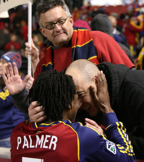 Leah Hogsten  | The Salt Lake Tribune
Real Salt Lake midfielder/defender Lovel Palmer (7) celebrates the win with a friend from the stands. Real Salt Lake defeated the Portland Timbers 4-2  during their first leg of the Western Conference final series Sunday, November 10, 2013 at Rio Tinto Stadium.