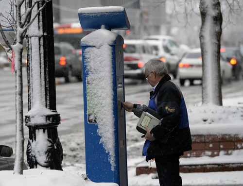 Al Hartmann  |  The Salt Lake Tribune
A man pays for parking at a snow-plastered kiosk in Salt Lake City during the first major winter snowstorm of the season along the Wasatch Front Tuesday December 3.