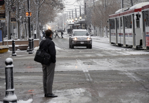 Al Hartmann  |  The Salt Lake Tribune
Commuters negotiate an icy, snow packed intersection and 200 South and Main Street in downtown Salt Lake City from the first winter snowstorm of the season Tuesday December 3.