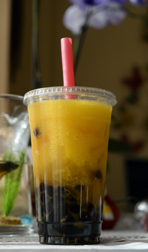 Al Hartmann  |  The Salt Lake Tribune
A mango chewing drink needs a fat straw for the large mango chunks and tapioca at the bottom of the glass at Boba World Shanghai Cuisine at 750 S. Highway 89 in Woods Cross.