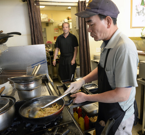 Al Hartmann  |  The Salt Lake Tribune
Chef Dawson Li prepares Shanghai Fat Noodles and vegetables over hot woks at Boba World Shanghai Cuisine.