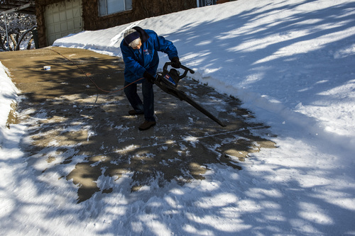 Chris Detrick  |  The Salt Lake Tribune
Neva Paschal, 90, uses a leaf blower to clear the snow off of her driveway in Salt Lake City Wednesday Dec. 4, 2013.