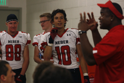 Scott Sommerdorf   |  The Salt Lake Tribune
Weber WR Nick Austin, 10, listens as assistant coach Andre Dyson speaks during halftime at West, Friday, August 23, 2013. Weber won 27-7 and snapped a 23-game losing streak.